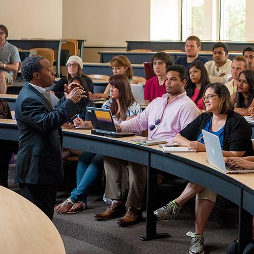 Professor teaching to a class of students.