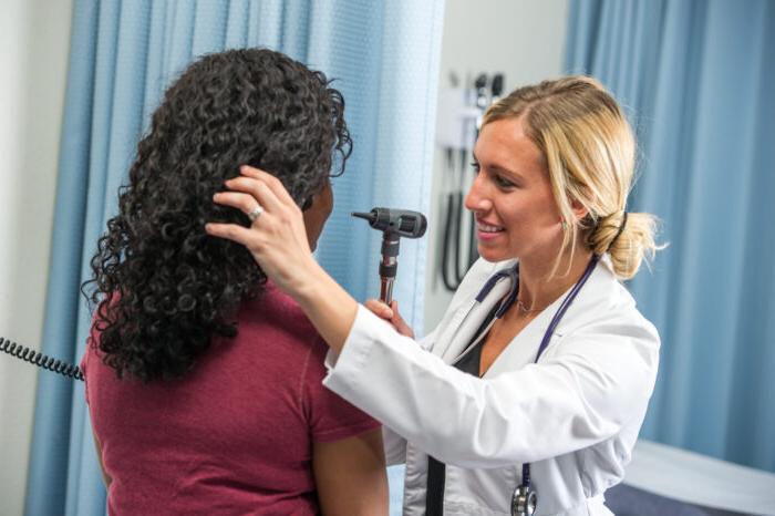 Nursing students evaluating a patient.