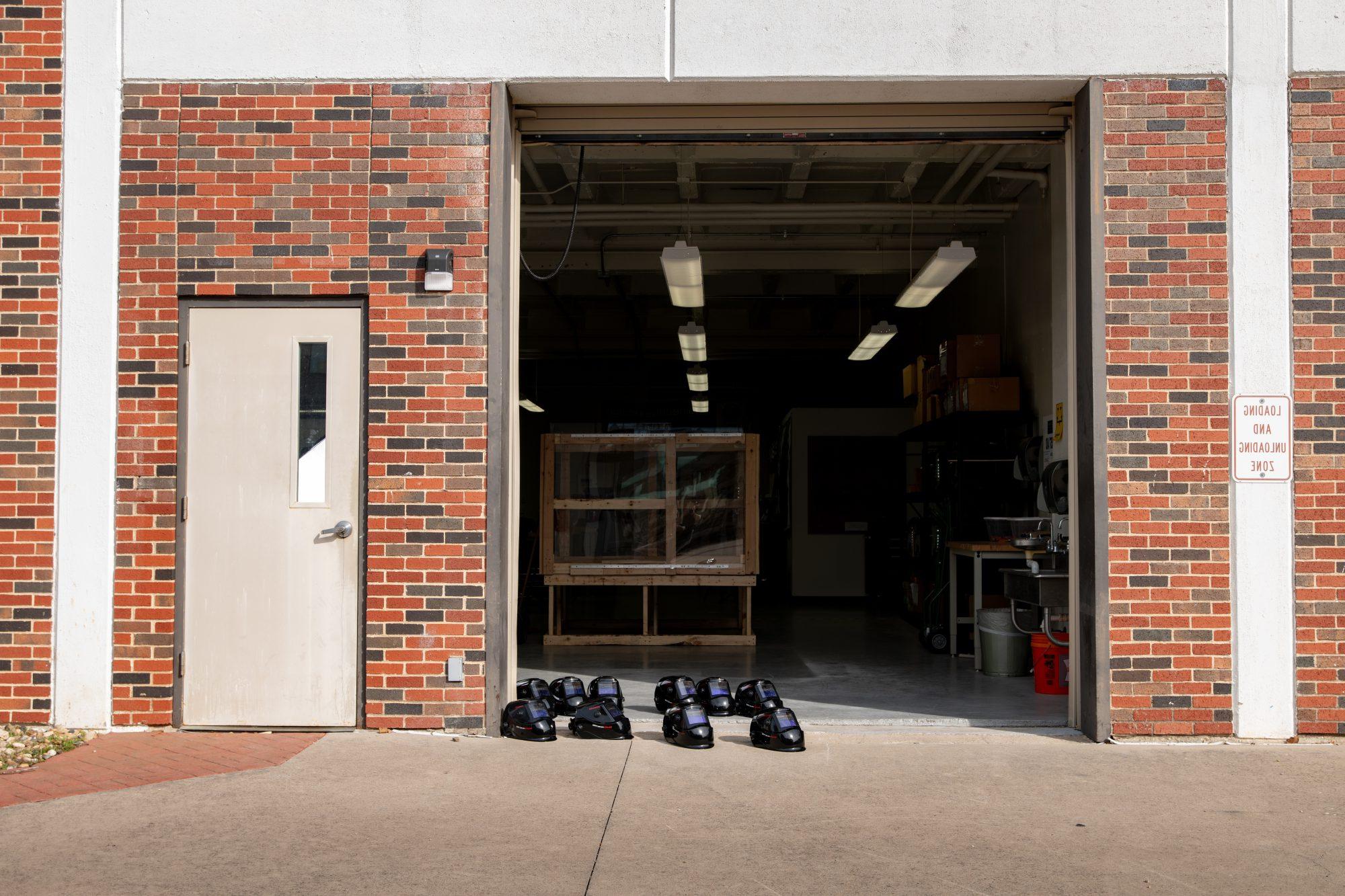 A garage door with eye protective on the floor.