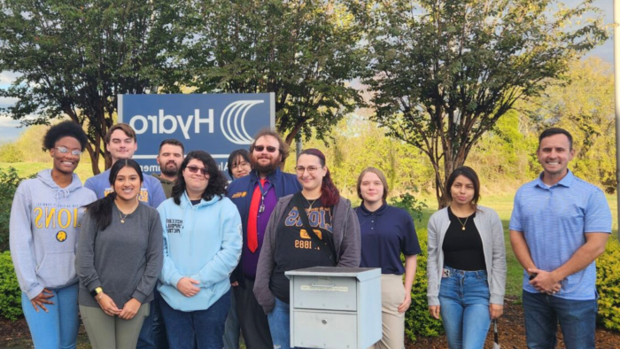 A group of people pose for a photo outdoors.